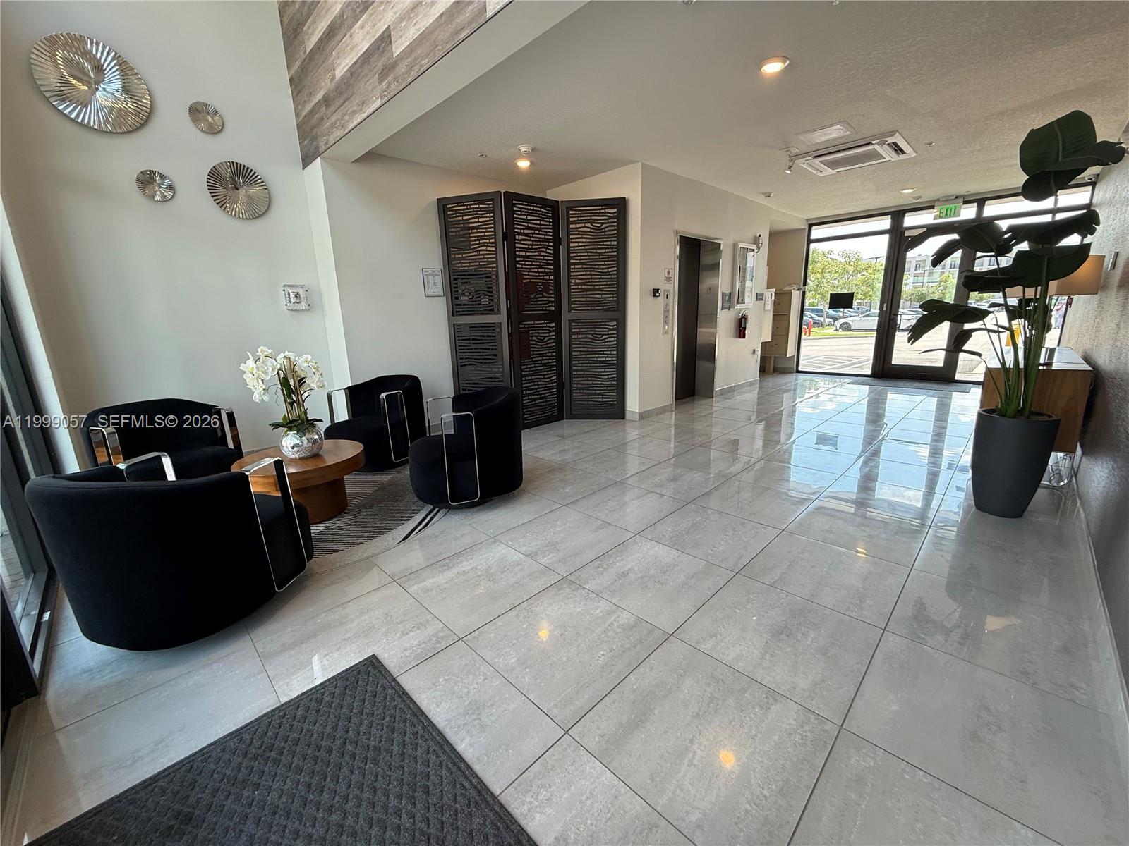 8167 Northwest 41st Street, Unit E409 Doral, FL 33166 - Photo 4 of 30 a living room with furniture