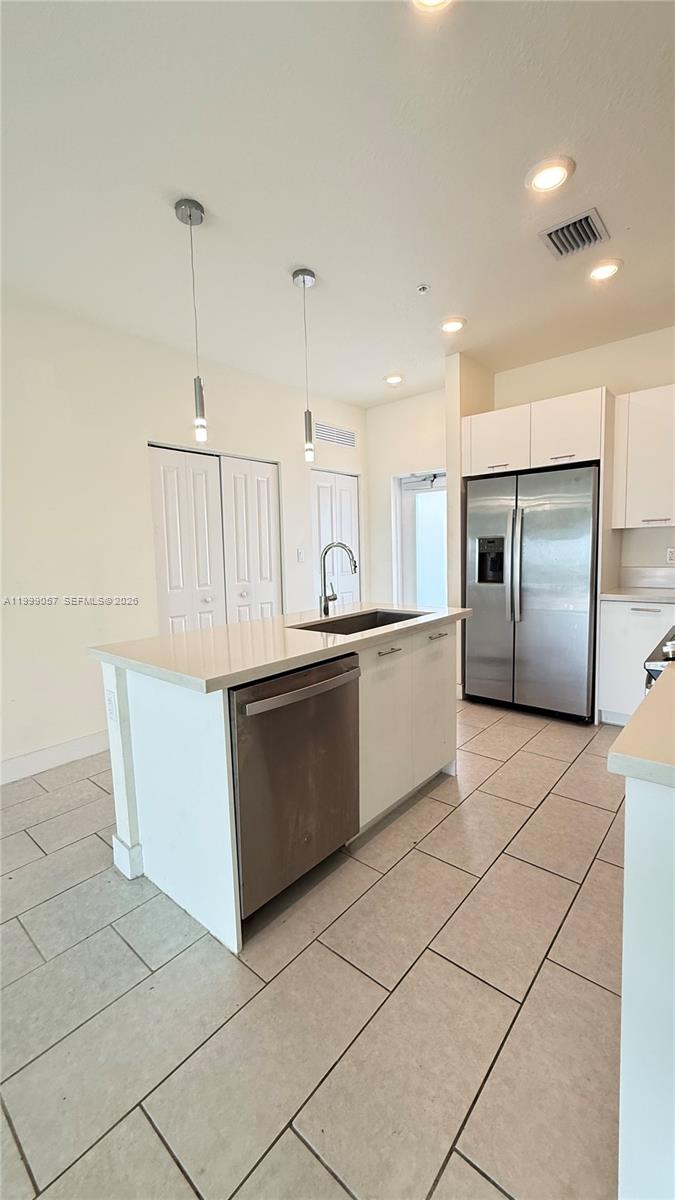 8167 Northwest 41st Street, Unit E409 Doral, FL 33166 - Photo 8 of 30 a kitchen with stainless steel appliances a refrigerator sink and microwave