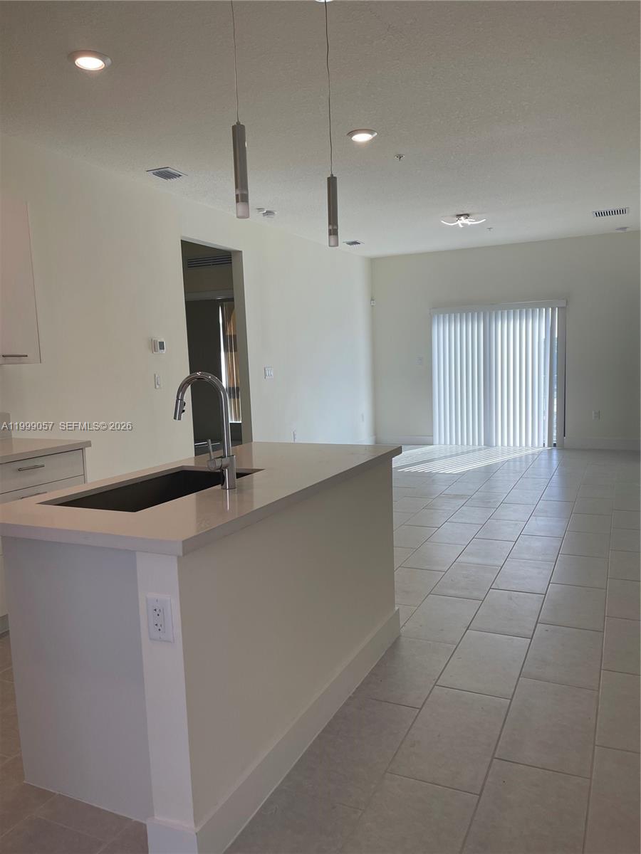 8167 Northwest 41st Street, Unit E409 Doral, FL 33166 - Photo 10 of 30 a view of a kitchen with a sink and a window
