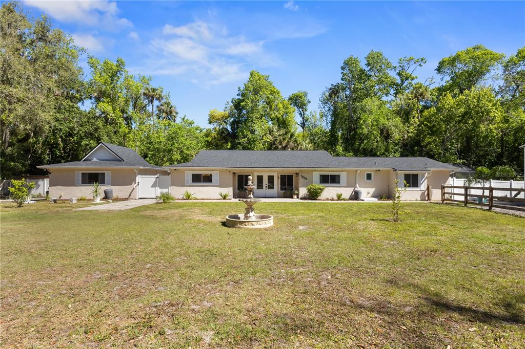 1705 Turtle Hill Road Deltona, FL 32725 - Photo 1 of 1 a front view of a house with garden