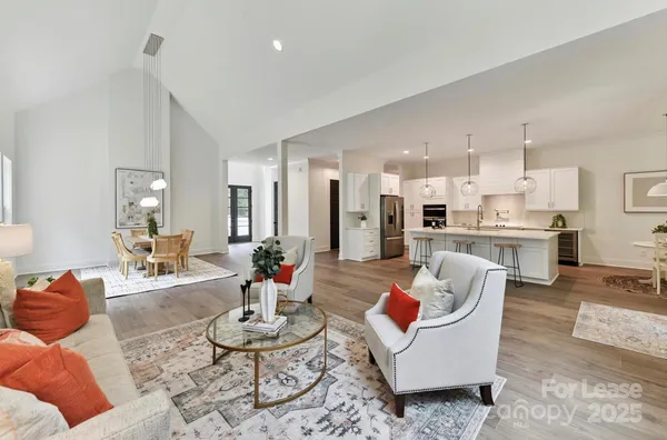 a living room with furniture and kitchen view