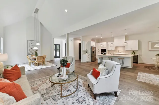 a living room with furniture and kitchen view