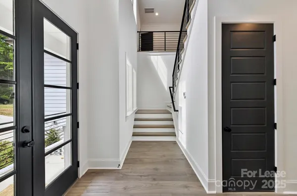 a view of entryway and hall with wooden floor