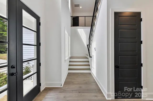 a view of entryway and hall with wooden floor