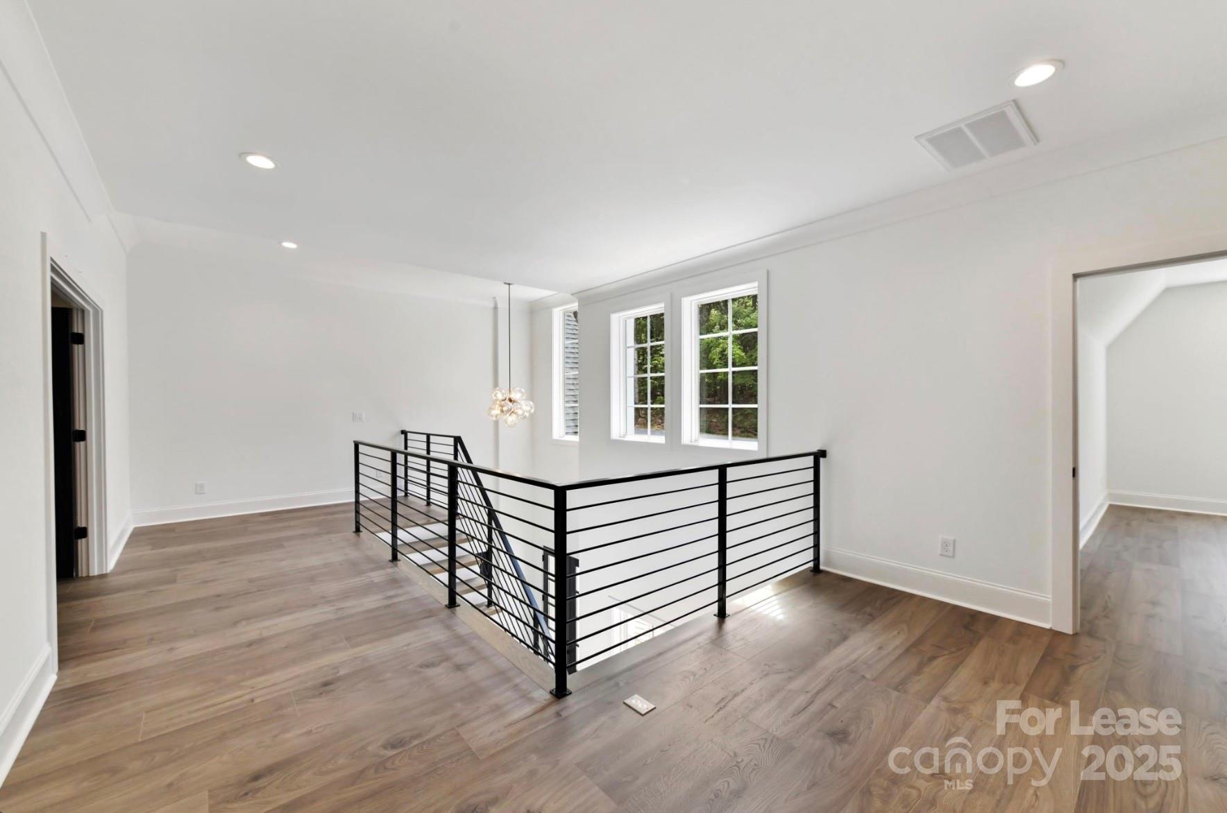 3830 Mill Run Terrell, NC 28682 - Photo 19 of 32 an empty room with wooden floor and windows