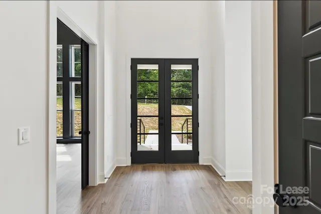 a view of hallway with wooden floor
