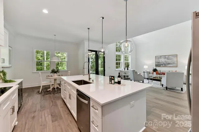 a kitchen with sink stove and refrigerator