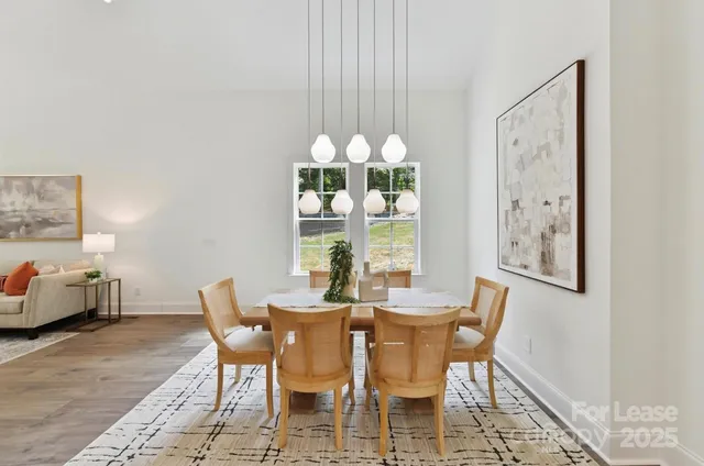 a view of a dining room with furniture and chandelier