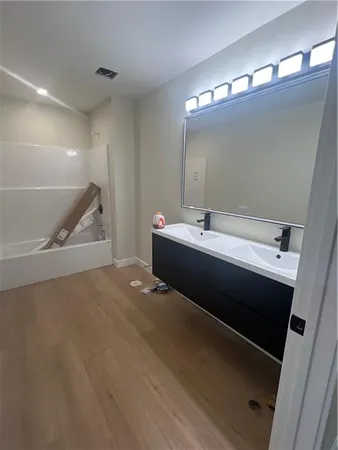 a en suite bathroom with a double vanity sink and a mirror