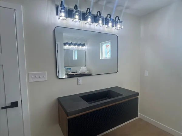 a bathroom with a sink and a mirror