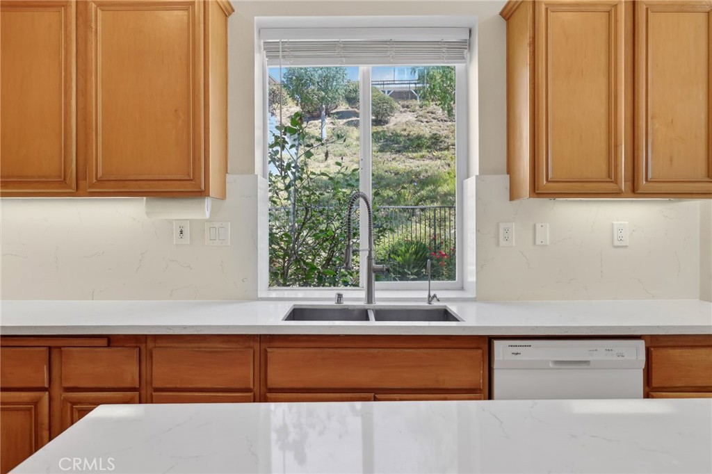 20543 Pesaro Porter Ranch Porter Ranch, CA 91326 - Photo 24 of 67 a kitchen with a window a sink and a counter top space