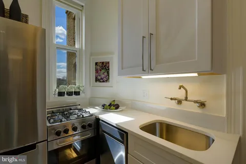 a kitchen with granite countertop a sink and a stove