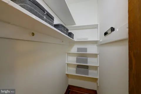 a view of walk in closet with empty racks