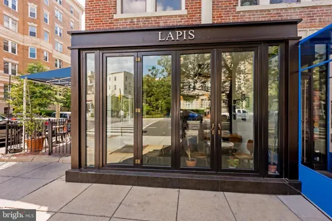 a view of a brick building from a glass door