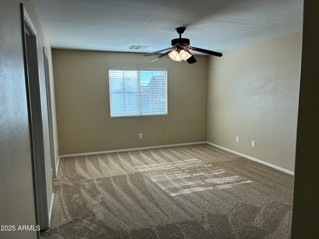 a view of a room with a ceiling fan