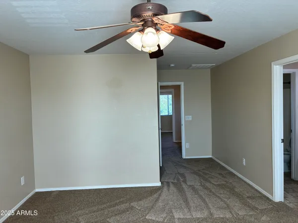 a view of a chandelier fan and closet