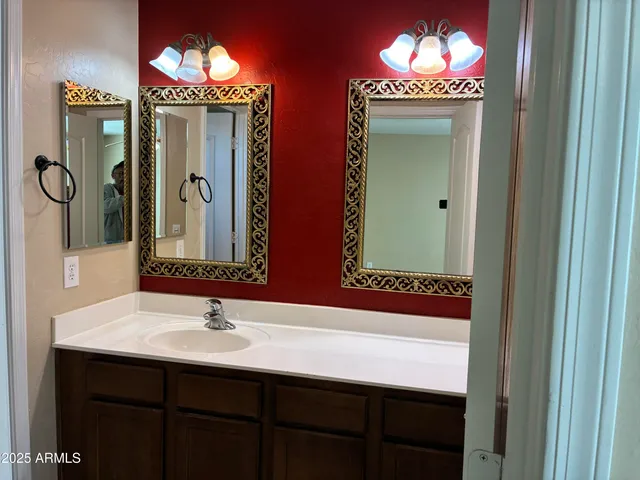 a bathroom with mirror and sink