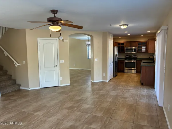a view of a kitchen with a sink and a refrigerator