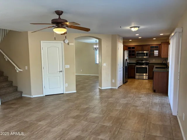 a view of a kitchen with a sink and a refrigerator