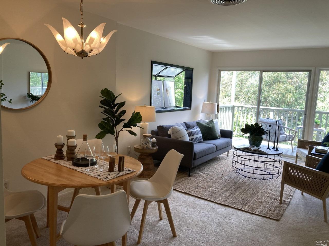 32 Ross Road Sausalito, CA 94965 - Photo 1 of 1 a living room with furniture a large window and a chandelier