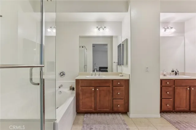 a view of a swimming pool with a lawn chairs under palm trees