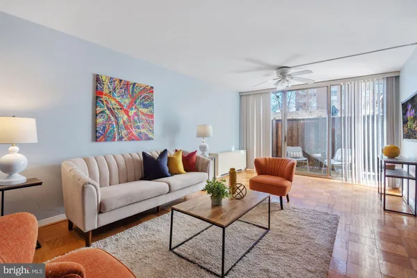 a living room with furniture and a wooden floor