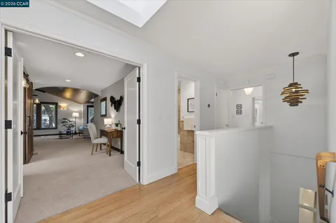 a spacious bedroom with a bed a couch and large window