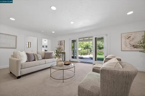 a view of washer and dryer with kitchen in the background