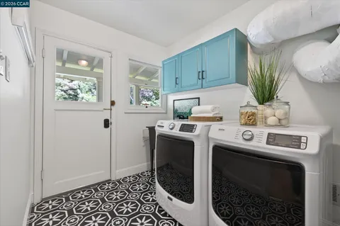 a view of a house with backyard swimming pool and sitting area