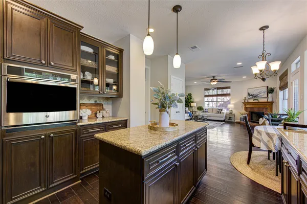 a living room with furniture fireplace and a large window