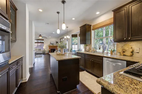 a living room with furniture a fireplace and a large window