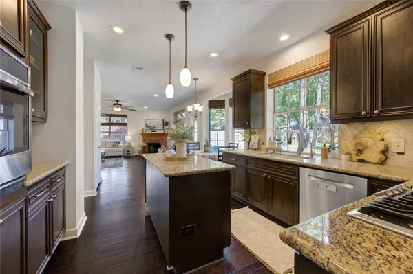 a living room with furniture a fireplace and a large window