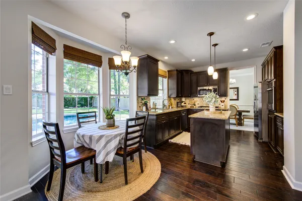 a spacious bedroom with a bed and a chandelier
