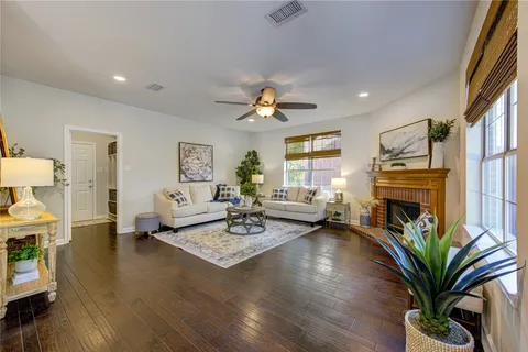 a spacious bedroom that has a bed and a chandelier