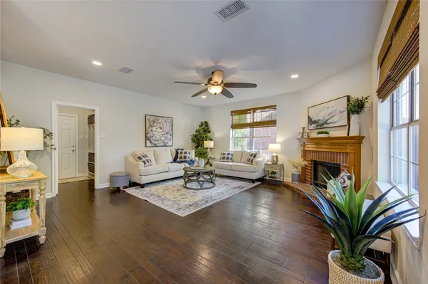 a spacious bedroom that has a bed and a chandelier