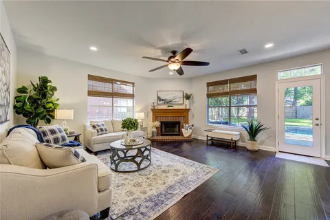 a bathroom with a granite countertop sink mirror vanity bathtub and next to a window
