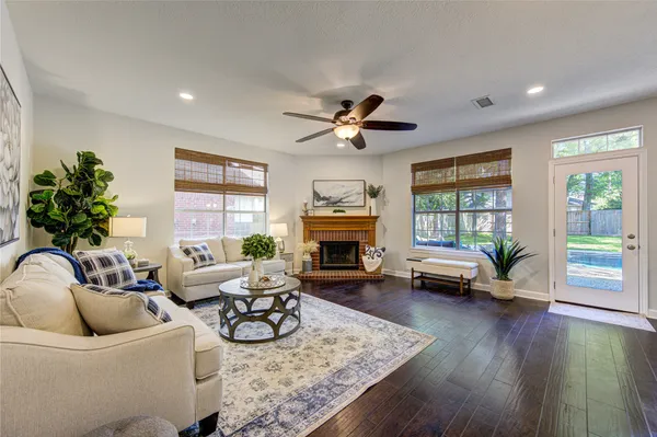 a bathroom with a granite countertop sink mirror vanity bathtub and next to a window
