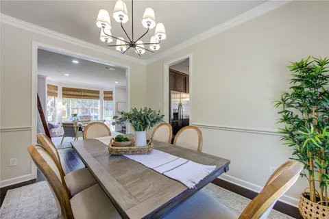a kitchen with kitchen island granite countertop a sink a counter space appliances and cabinets