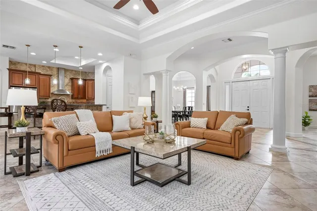 a view of a dining room with furniture and a chandelier