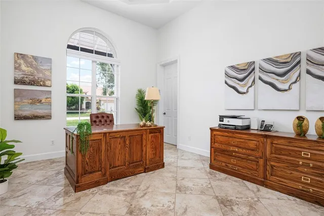 a spacious bedroom with a bed and large window