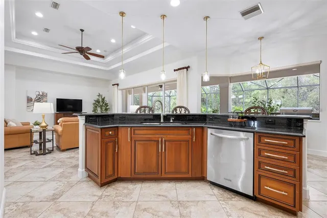 a kitchen with stainless steel appliances granite countertop a sink stove and cabinets