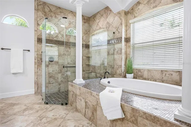a view of a patio with table and chairs potted plants and large tree
