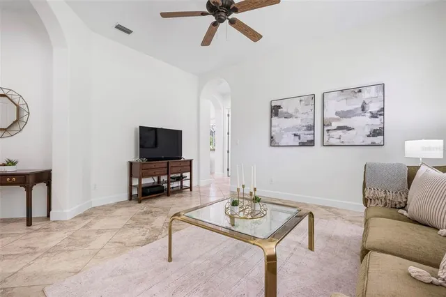 an aerial view of ocean and residential houses with outdoor space