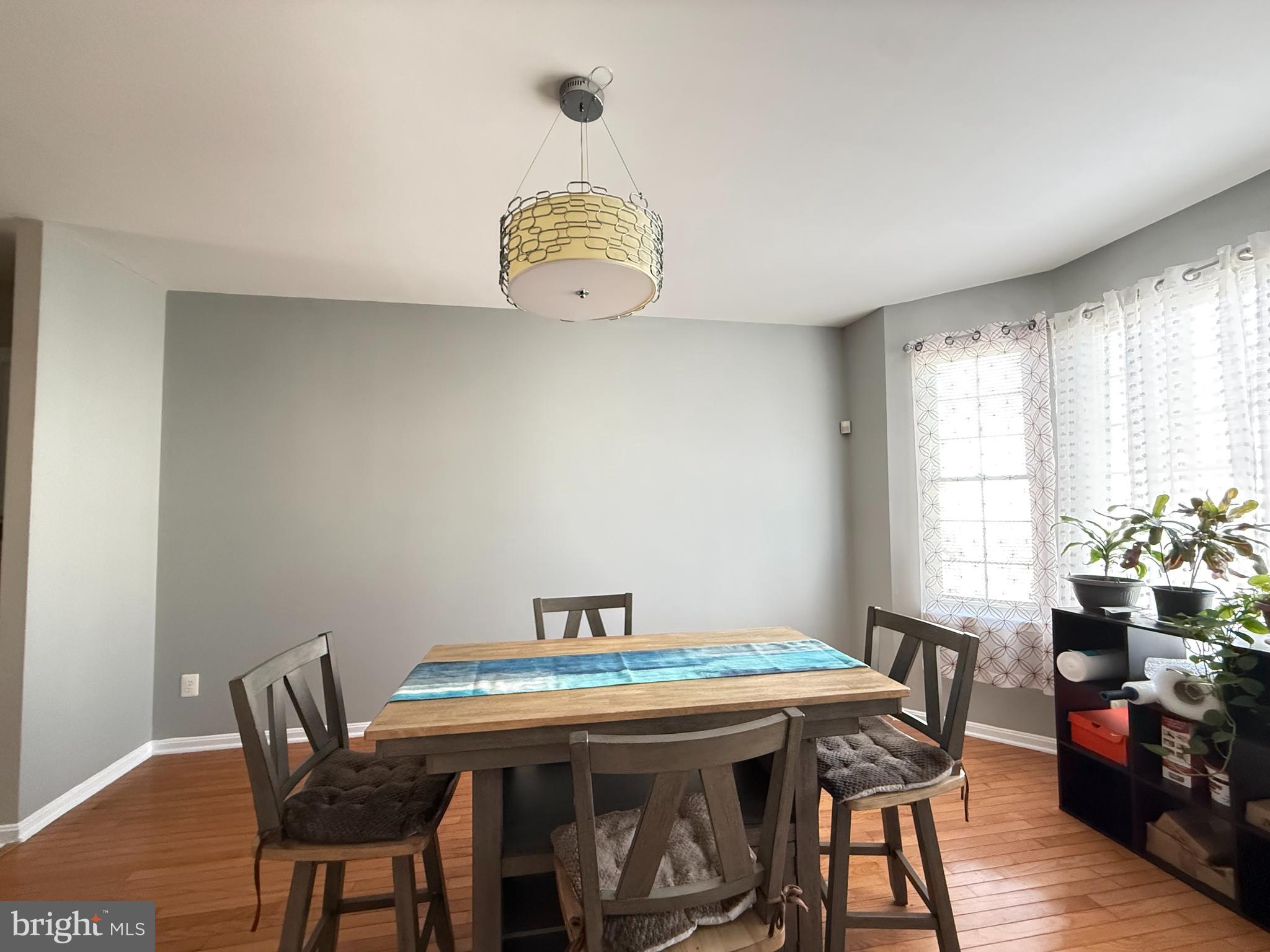 215 Seamaster Road Essex, MD 21221 - Photo 11 of 34 a view of a dining room with furniture window and wooden floor
