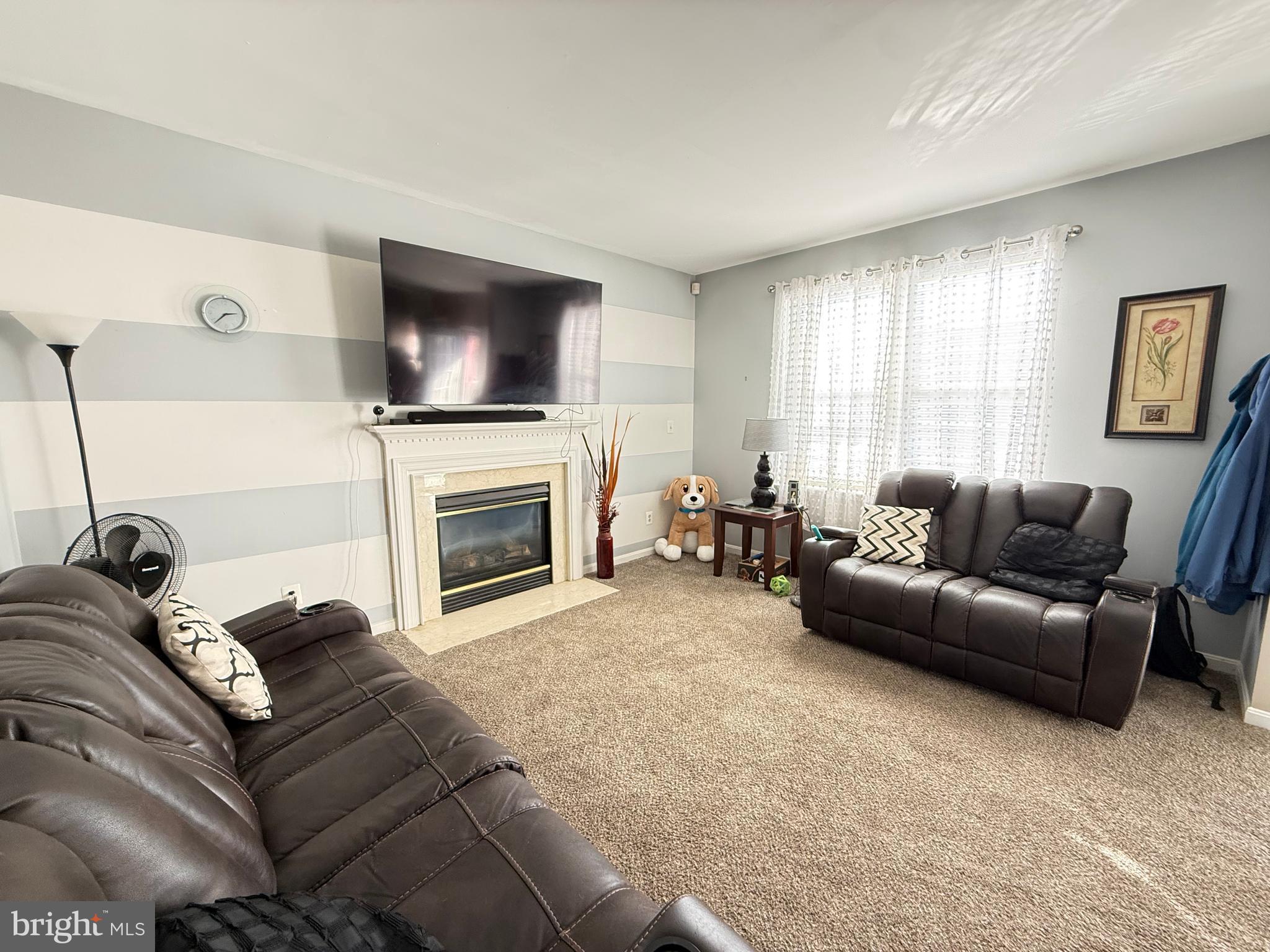 215 Seamaster Road Essex, MD 21221 - Photo 12 of 34 a living room with furniture a flat screen tv and a fireplace