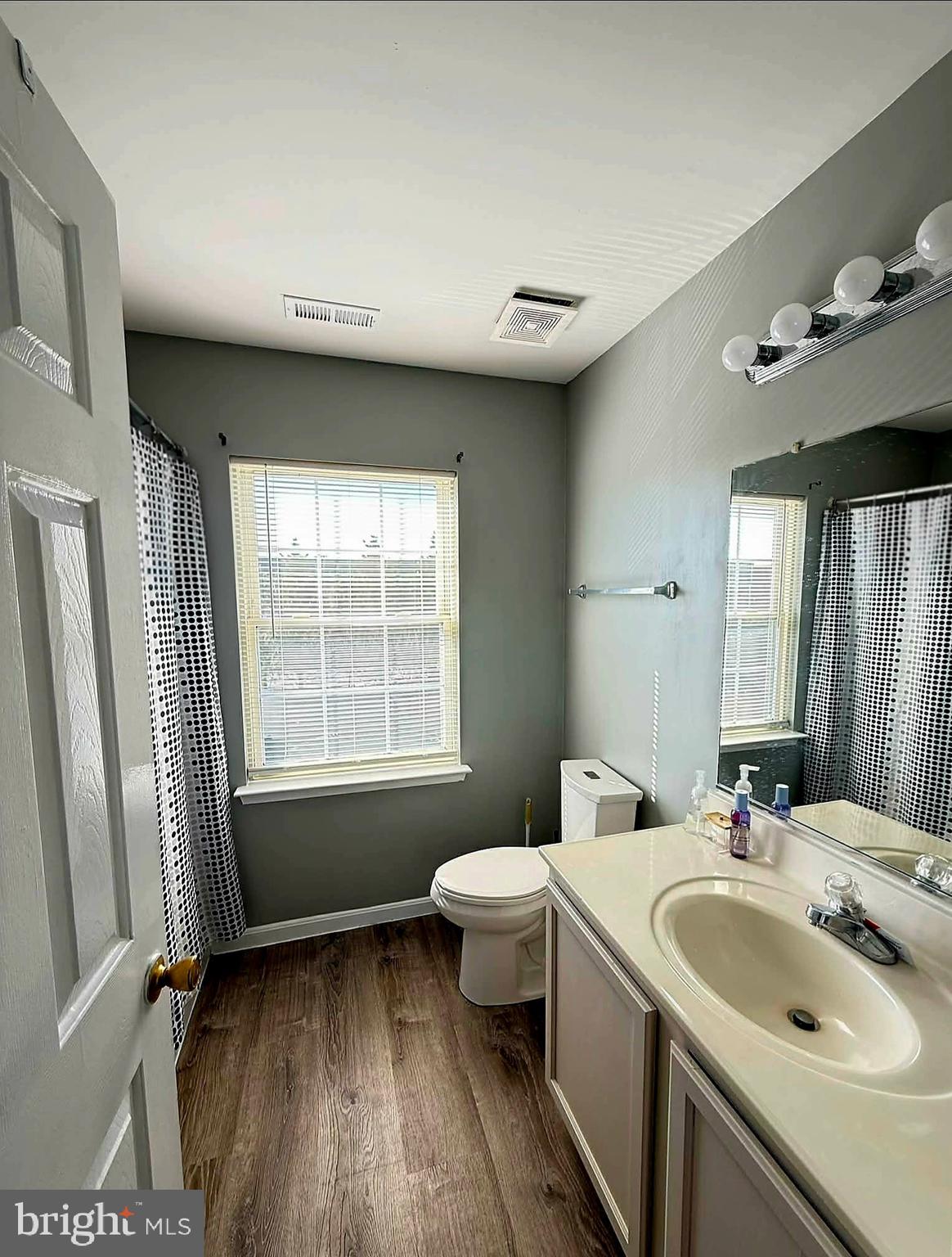215 Seamaster Road Essex, MD 21221 - Photo 19 of 34 a bathroom with a sink mirror and toilet
