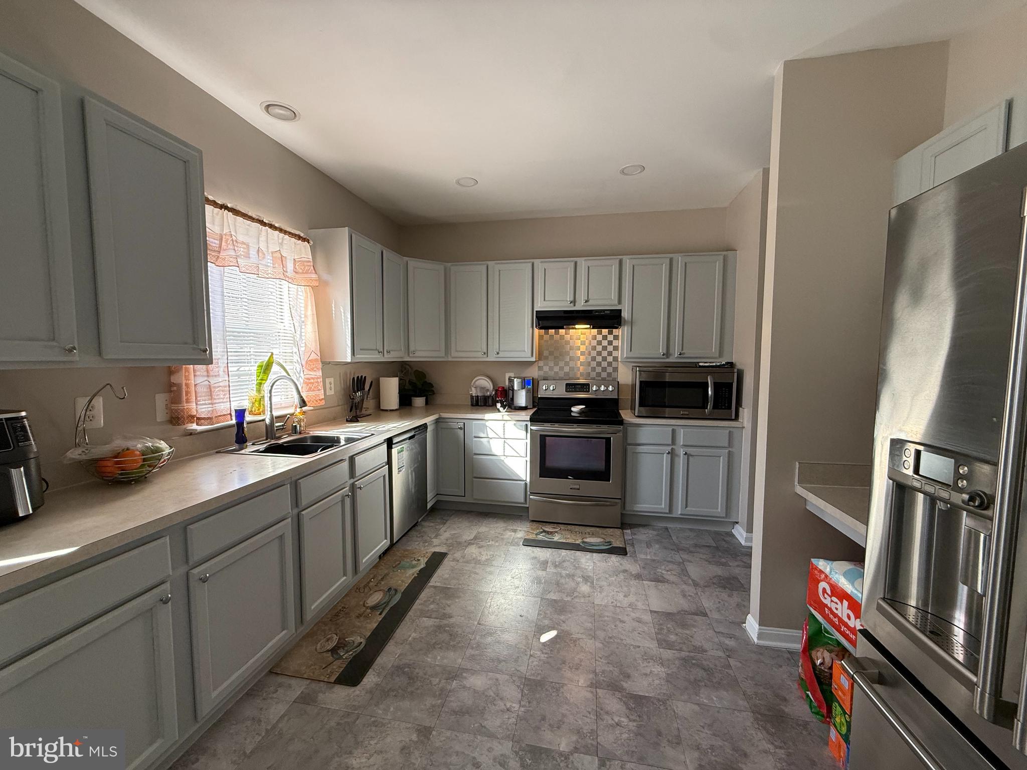215 Seamaster Road Essex, MD 21221 - Photo 2 of 34 a kitchen with refrigerator a sink and a stove