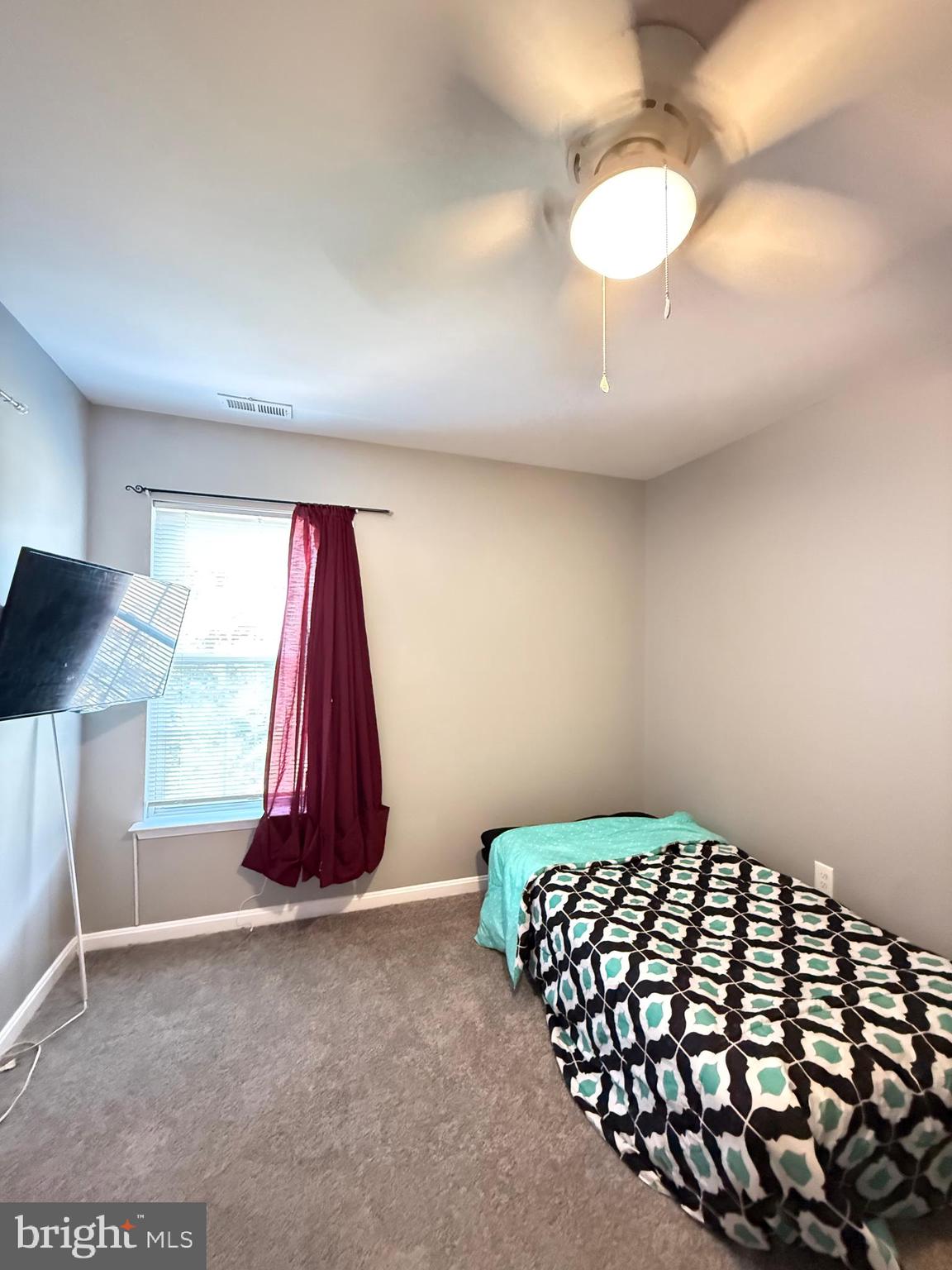 215 Seamaster Road Essex, MD 21221 - Photo 21 of 34 a bedroom with a bed and a chandelier