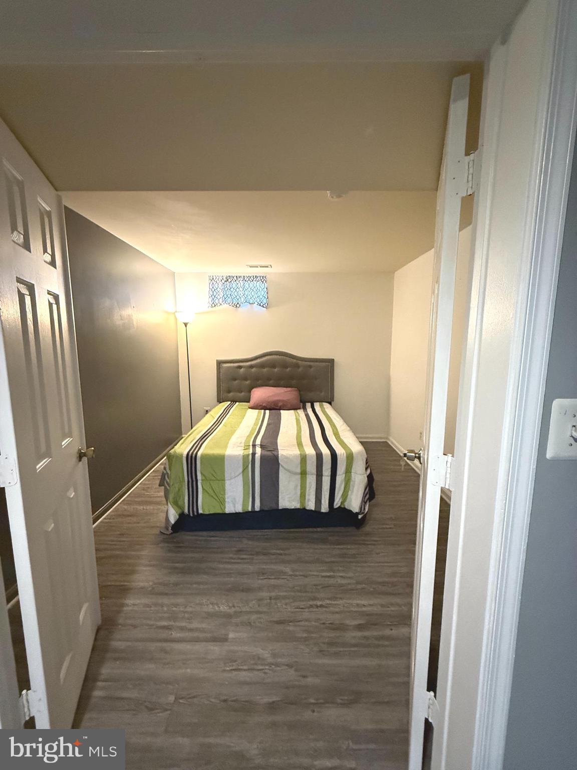 215 Seamaster Road Essex, MD 21221 - Photo 26 of 34 a bedroom with a bed and wooden floor