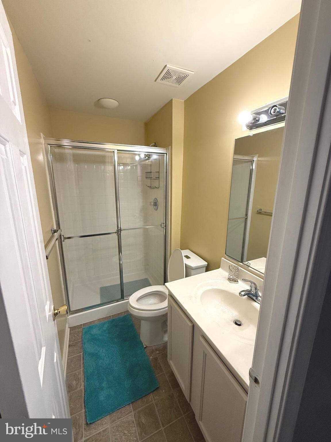 215 Seamaster Road Essex, MD 21221 - Photo 27 of 34 a bathroom with a sink a toilet a mirror and shower